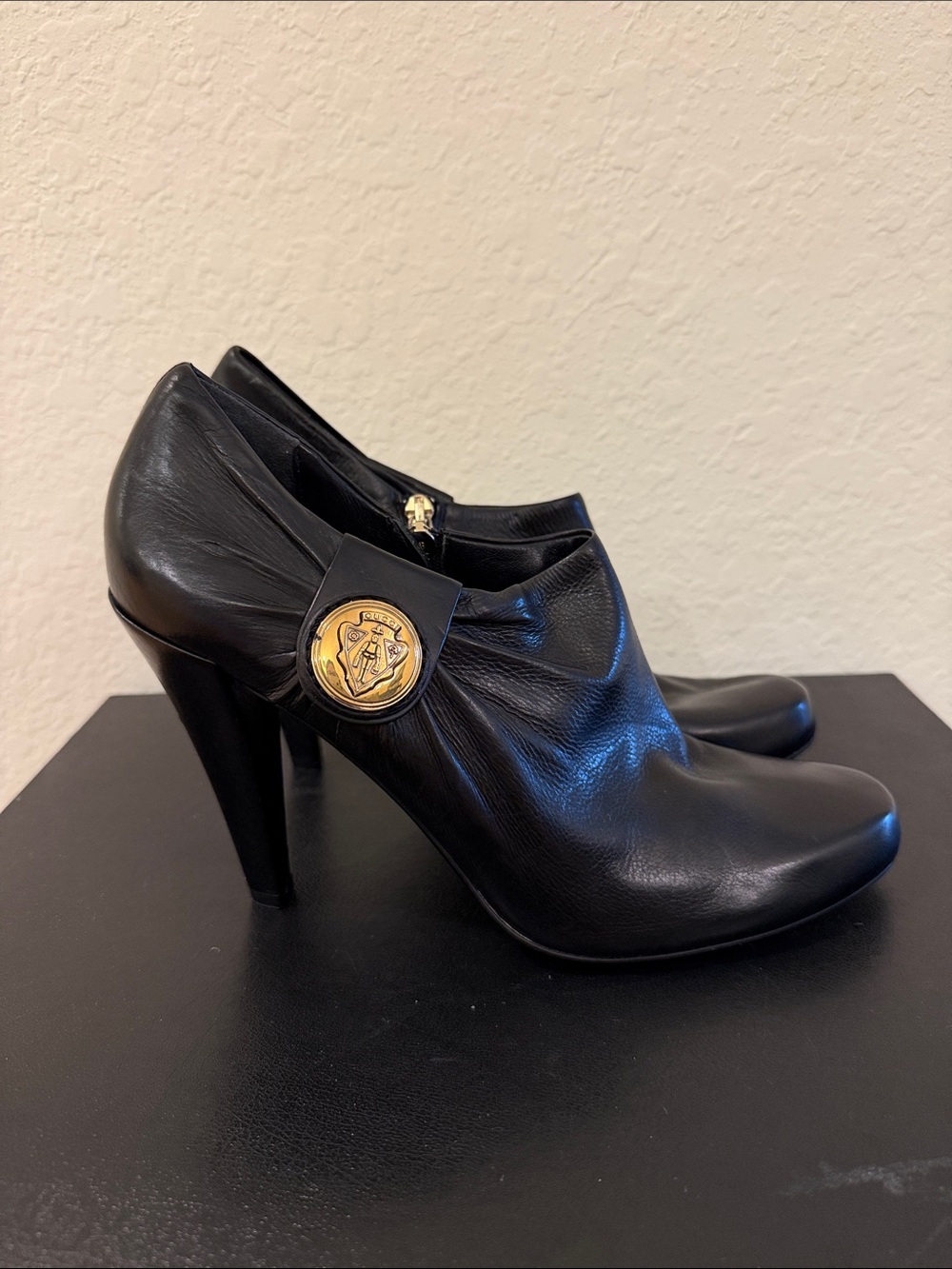 Gucci  NEVER WORN Black Leather High-Heel Ankle Booties - Gold Medallion Accent - Picture 3 of 7